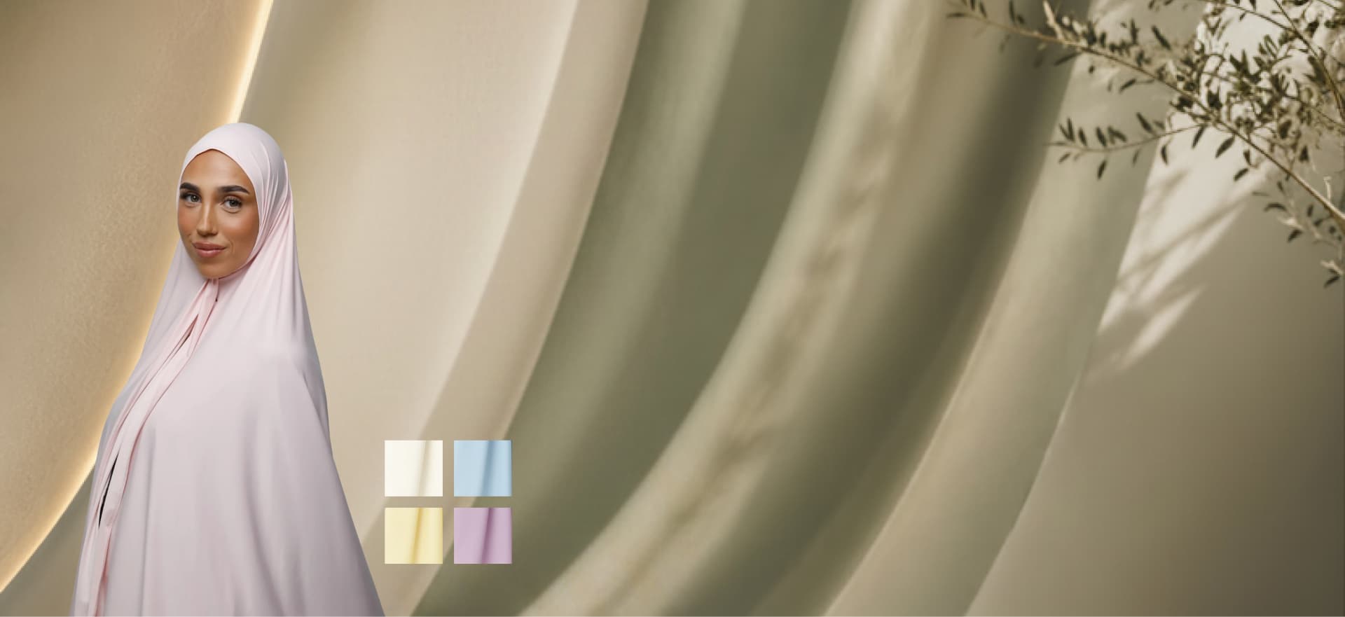 Model i lyserød khimar mod bløde stof draperinger med pastelfarvede stofprøver